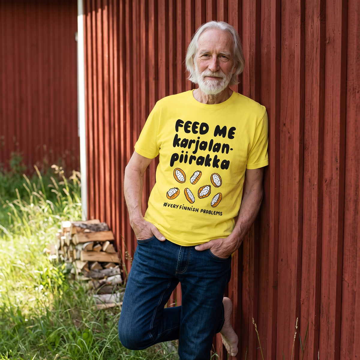 Feed Me Karjalanpiirakka t-shirt in yellow, worn by Pertti leaning on a red summer cottage wall, Very Finnish Problems