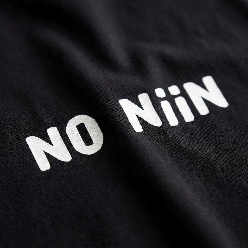No niin Finnish language t-shirt print detail close up on black fabric, Very Finnish Problems