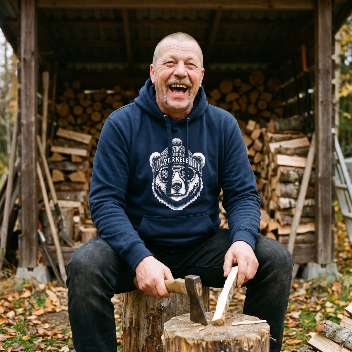 Perkele Bear hoodie in navy blazer, worn by Juha splitting kindling by a woodshed, Very Finnish Problems