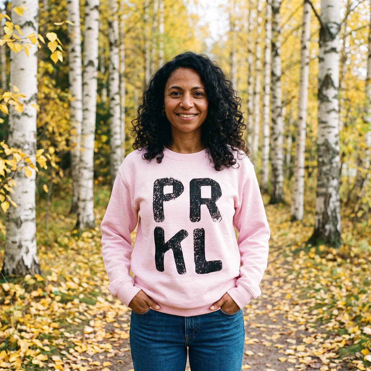 PRKL sweatshirt in light pink, worn by Nea in an autumn birch park, Very Finnish Problems