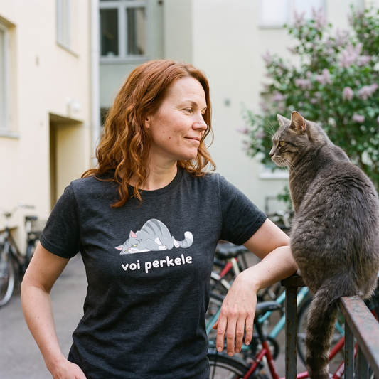 Voi perkele Cat t-shirt in dark grey heather, worn by Sanna in a Helsinki courtyard beside a cat ignoring her, Very Finnish Problems