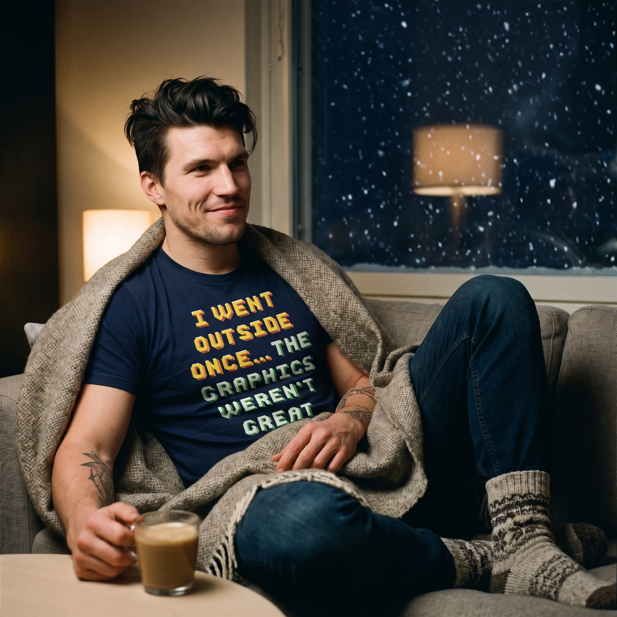 Went Outside Once t-shirt in navy, worn by a man wrapped in a blanket indoors on a snowy winter evening, Very Finnish Problems