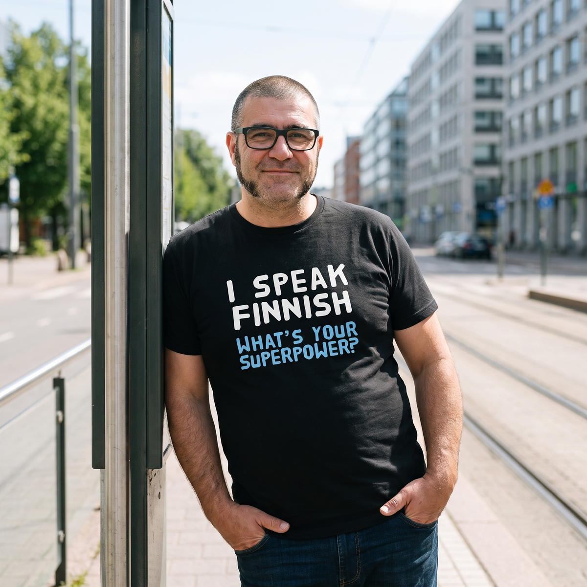 What's your superpower? organic t-shirt in black, worn by Jaska at a Helsinki tram stop, Very Finnish Problems