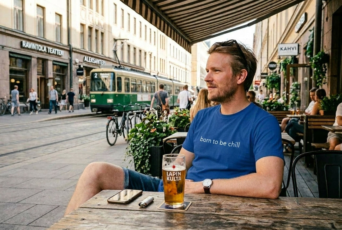 Finnish man relaxing with a drink on a sunny city bar terrace in summer