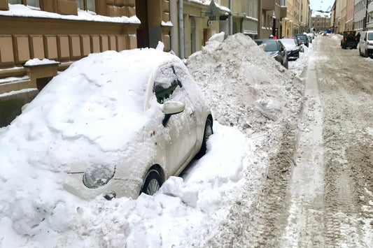 A snow-covered car on a Helsinki street in deep winter