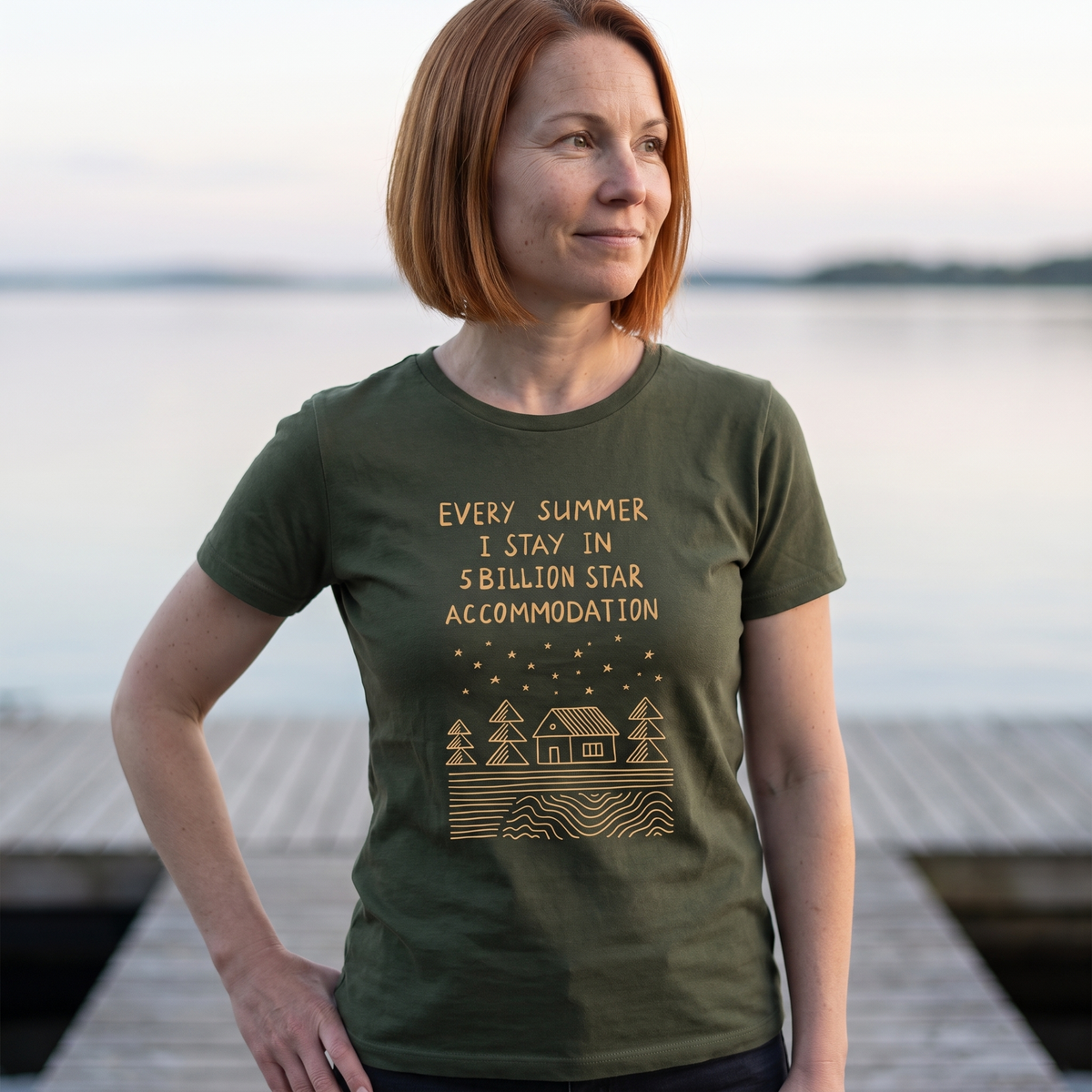 5 Billion Star Accommodation Finnish t-shirt in green olive, worn by Sanna on a lake jetty at midnight, Very Finnish Problems