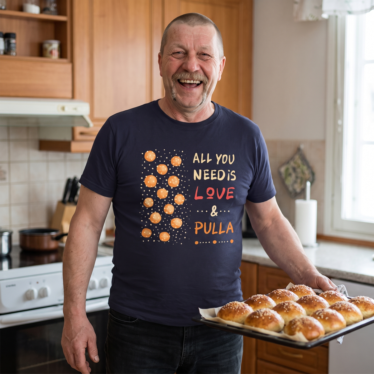 All You Need Is Love & Pulla t-shirt in navy, worn by Juha carrying a tray of fresh pulla, Very Finnish Problems