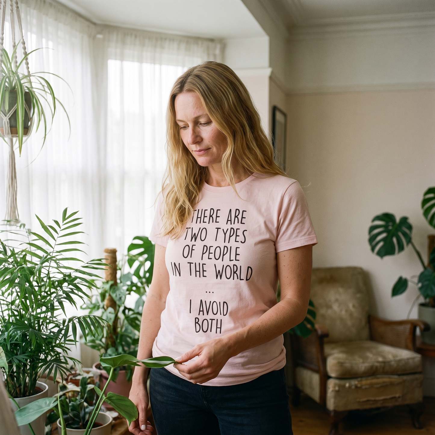 Two Types of People t-shirt in pink, worn by a woman among houseplants, Very Finnish Problems