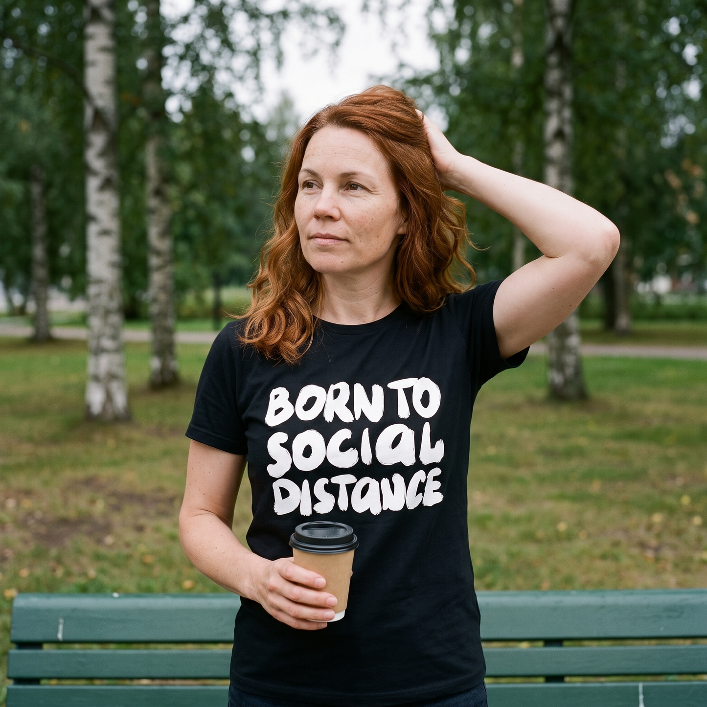 Born to Social Distance t-shirt in black, worn by Sanna alone at the end of a park bench, Very Finnish Problems