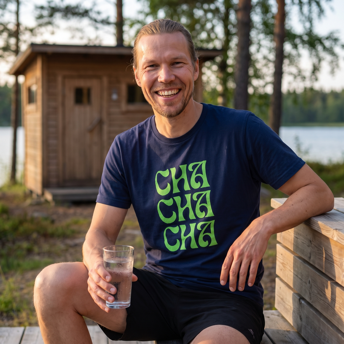 Cha Cha Cha t-shirt in navy, worn by Joonas on a lakeside sauna terrace, Very Finnish Problems