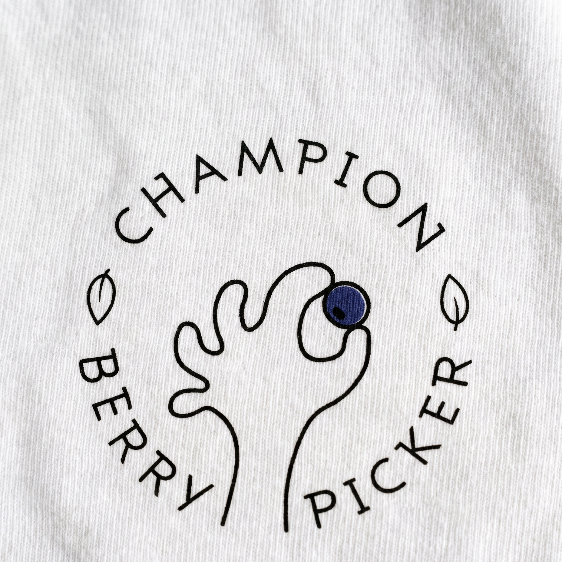 Champion Blueberry Picker print close up on white cotton, Very Finnish Problems