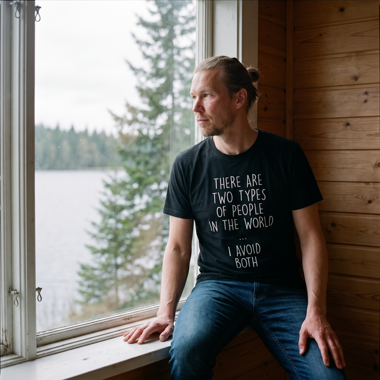 Two Types of People t-shirt in black, worn by a man sitting at a lakeside cottage window, Very Finnish Problems