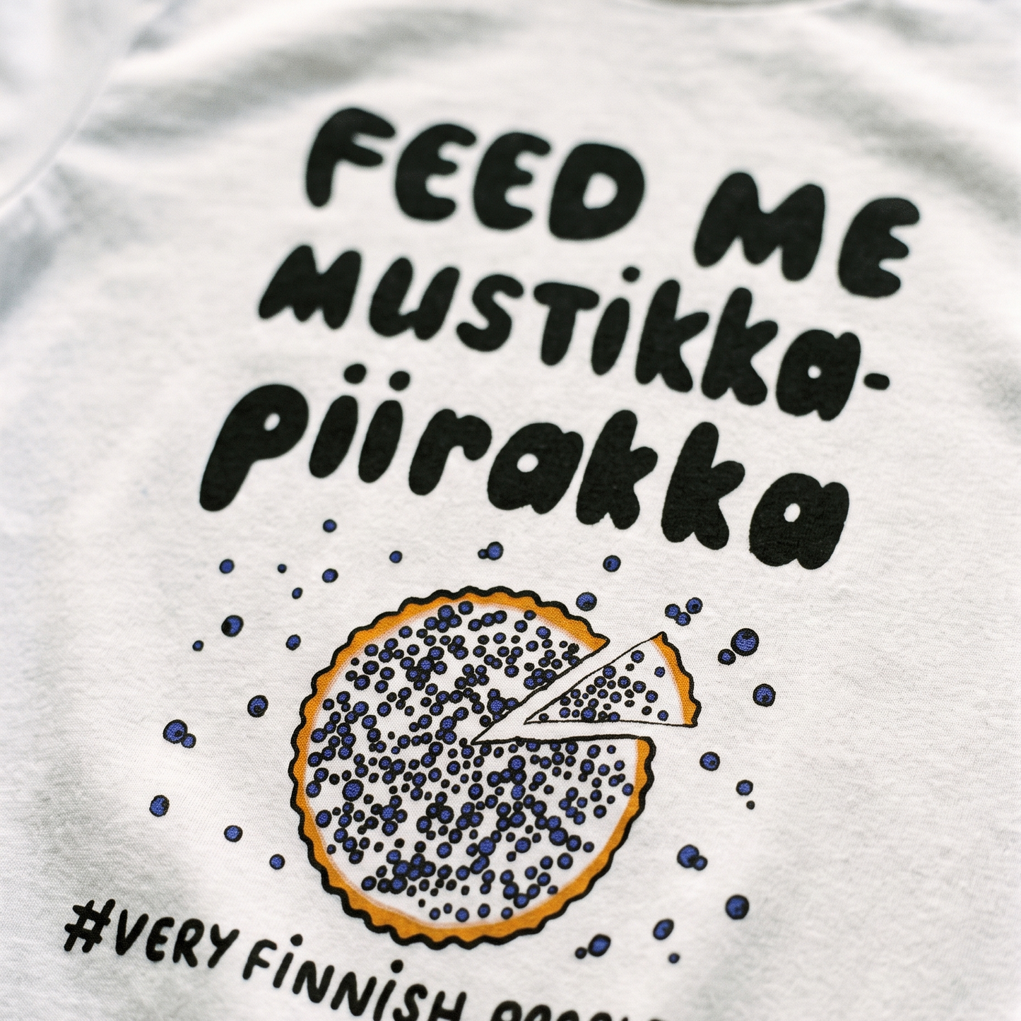 Feed Me Mustikkapiirakka print close up on white cotton, Very Finnish Problems