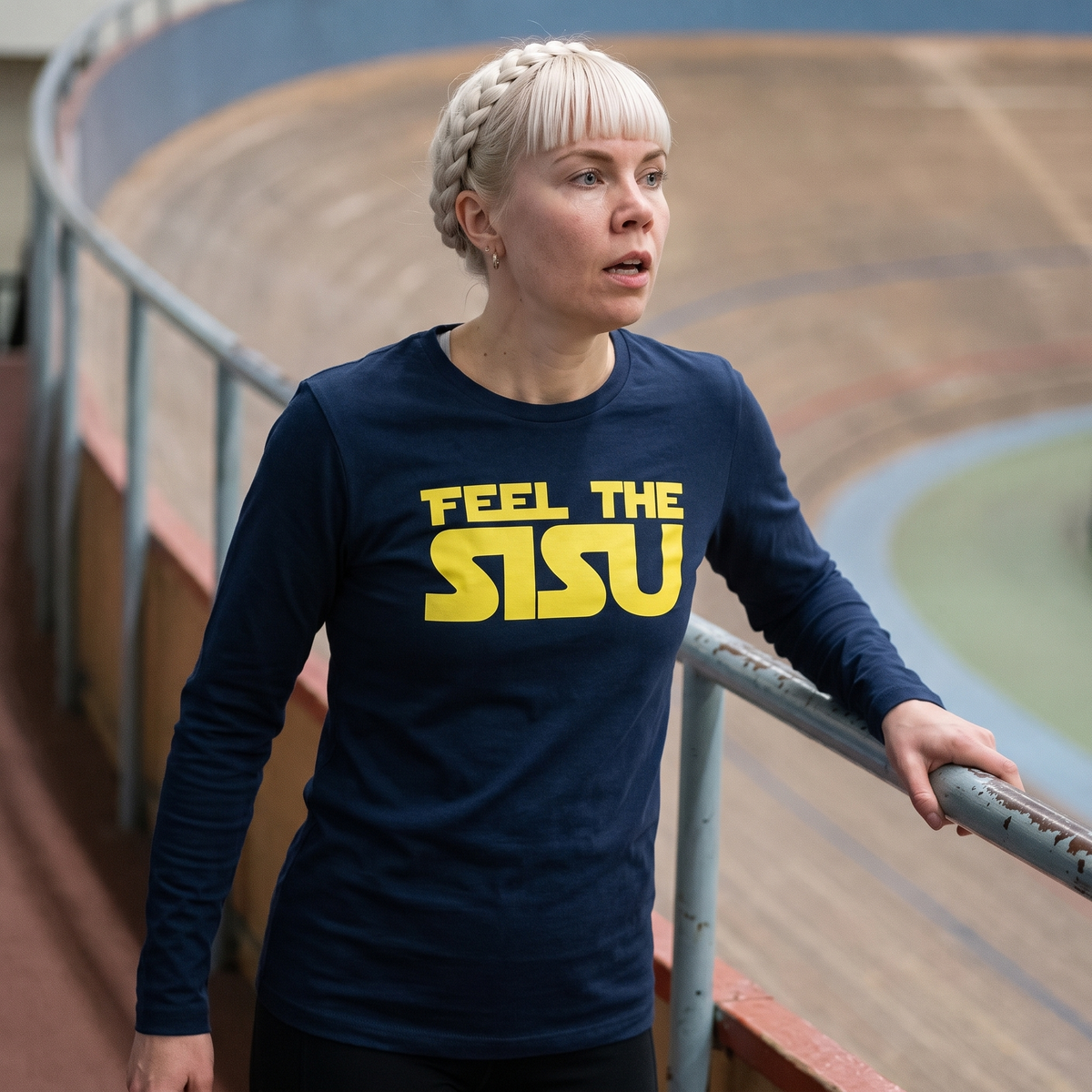 Feel the sisu Finnish culture long sleeve tee in navy, worn by Venla on an indoor running track, Very Finnish Problems