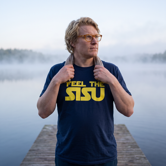 Feel the sisu Finnish organic cotton t-shirt in French navy, worn by Tuomas on a jetty at dawn, Very Finnish Problems