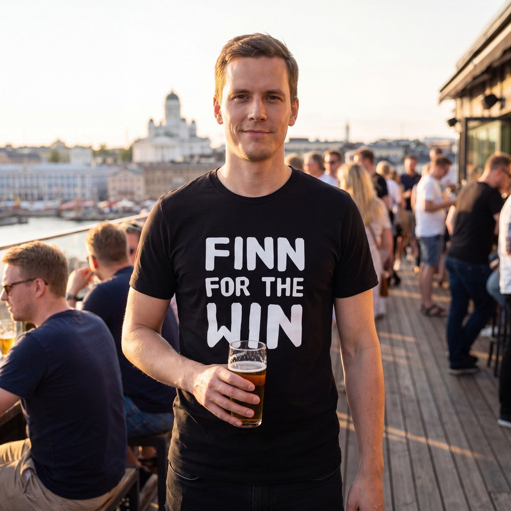 Finn for the Win Finnish sports t-shirt in black worn by a man celebrating on a Helsinki terrace, Very Finnish Problems