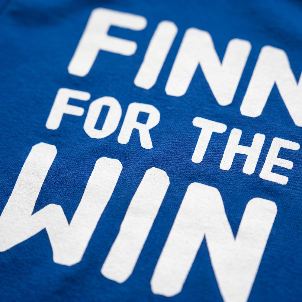 Finn for the Win Finnish sports t-shirt print detail close up on royal blue fabric, Very Finnish Problems