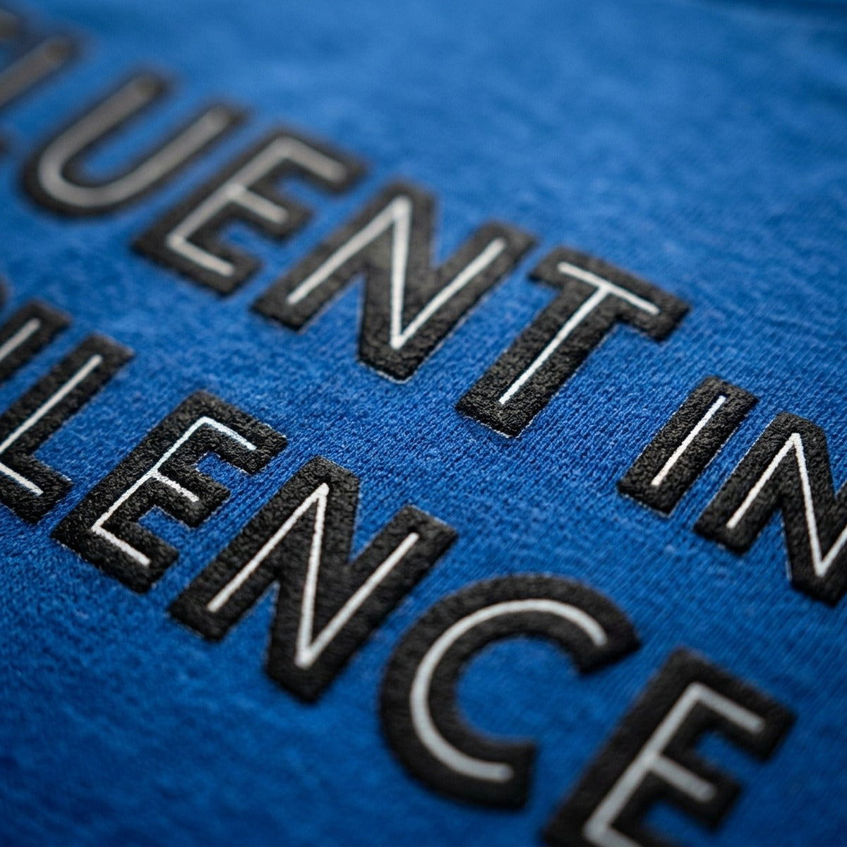 Close-up macro of royal blue Fluent in Silence print, Very Finnish Problems