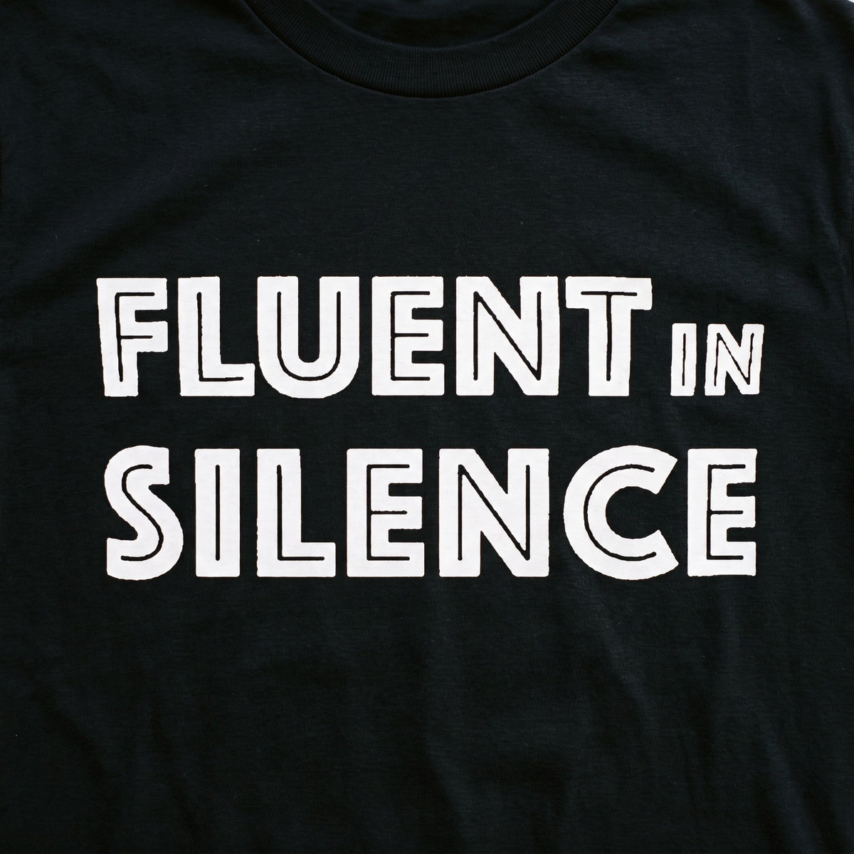 Close up of the Fluent in Silence print on a black t-shirt, Very Finnish Problems
