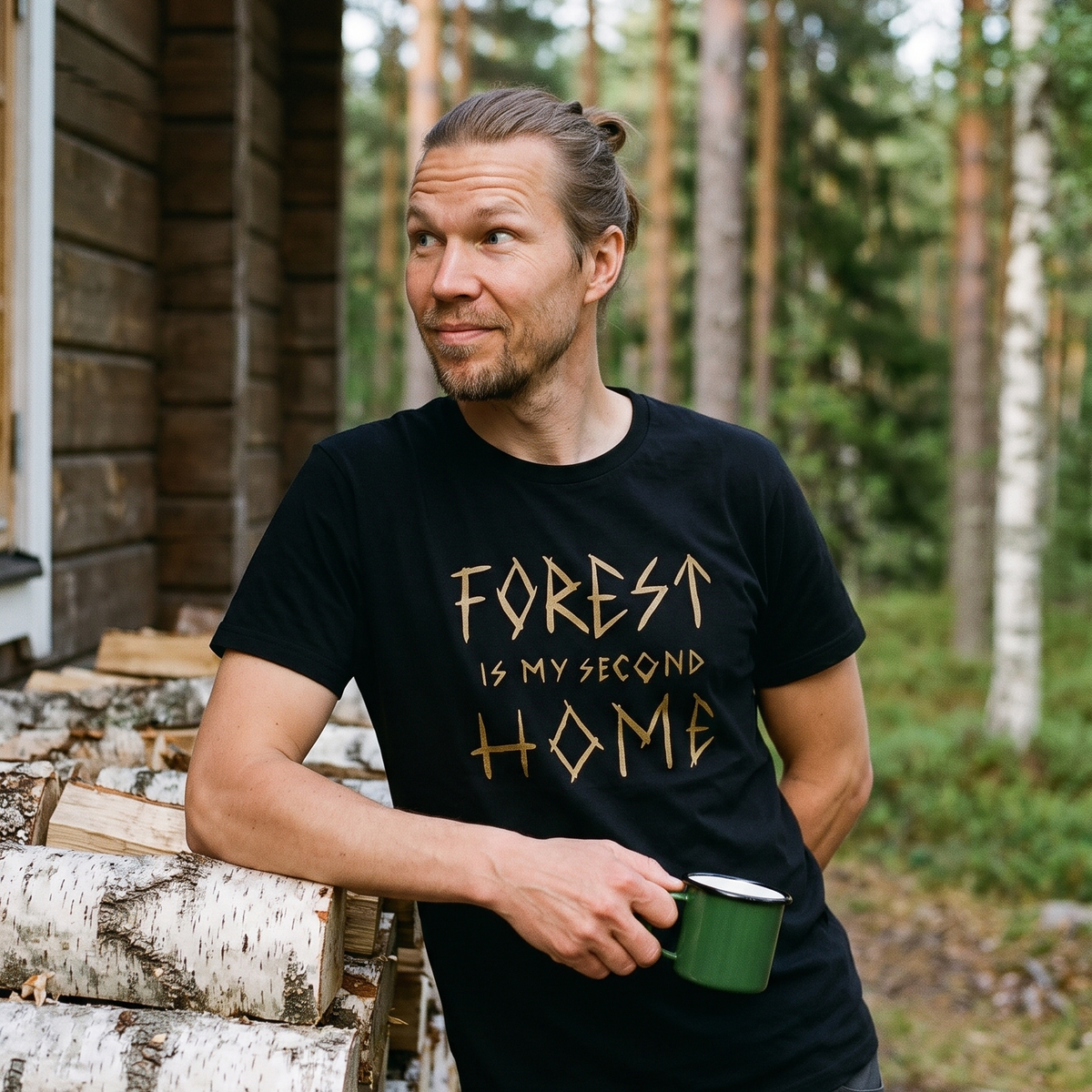 Forest Is Home t-shirt in black, worn by Joonas leaning on the woodpile at a Finnish summer cottage, Very Finnish Problems