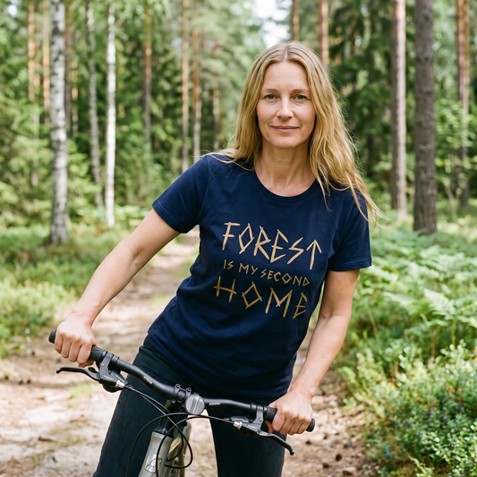 Forest Is Home t-shirt in navy, worn by Elina with a bicycle on a Finnish forest track, Very Finnish Problems