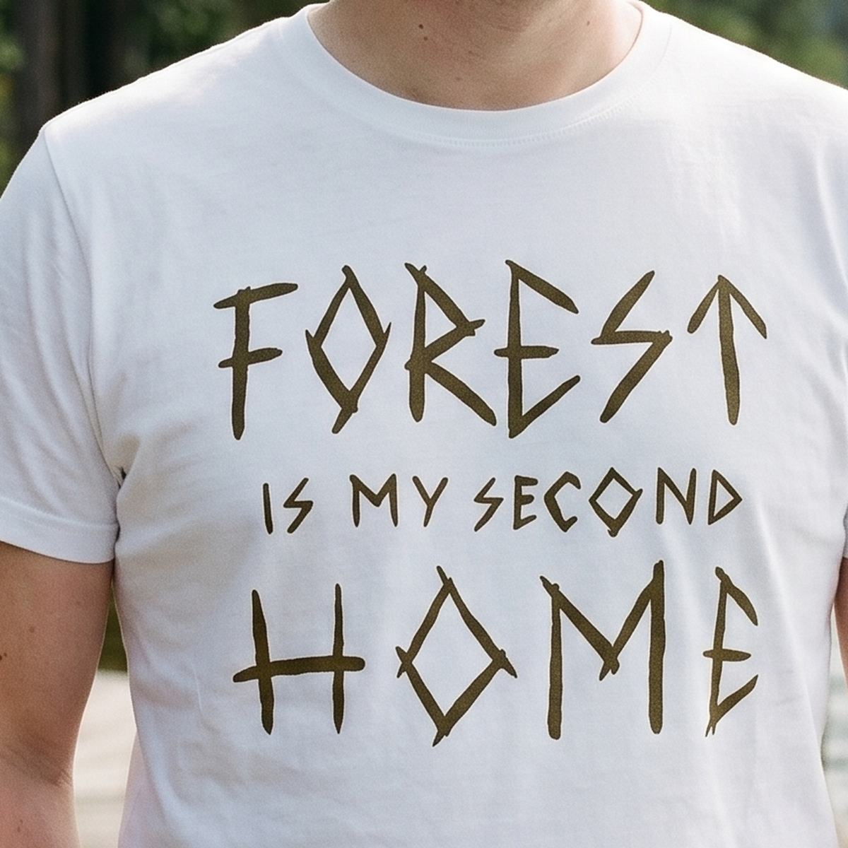 Close-up of the Forest Is My Second Home print in gold ochre on a white t-shirt, Very Finnish Problems