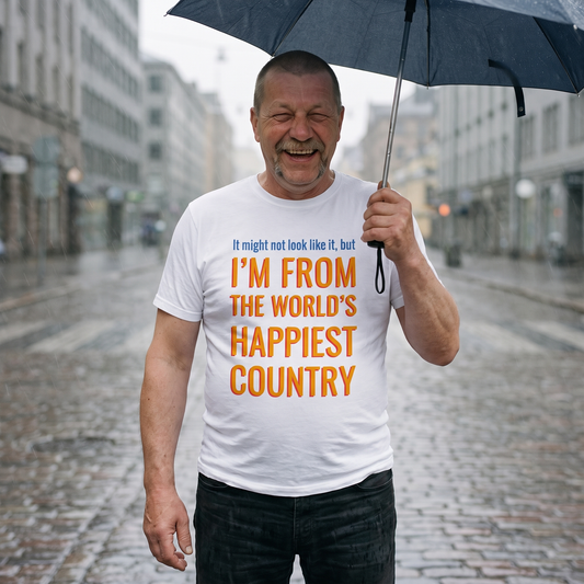 Happiest Country t-shirt in white, worn by Juha laughing under an umbrella in Helsinki drizzle, Very Finnish Problems