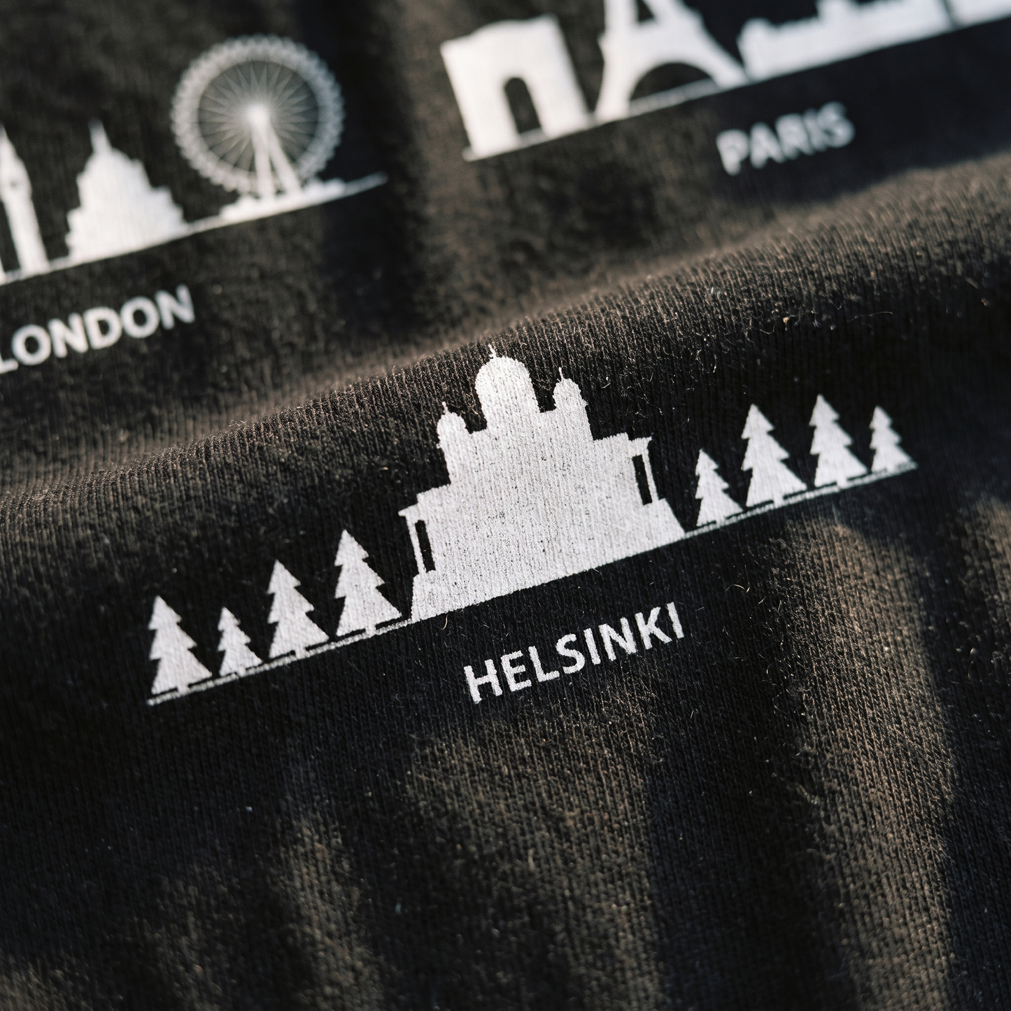 Close-up of the Helsinki Skyline print showing the cathedral and fir trees on black cotton, Very Finnish Problems