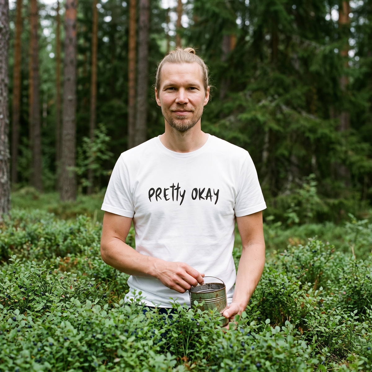 Pretty okay Finnish humour organic cotton t-shirt in white, worn by Joonas picking blueberries, Very Finnish Problems