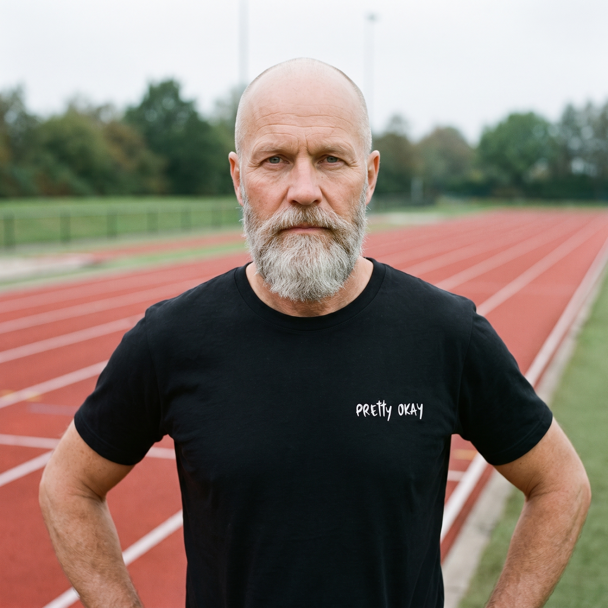 Pretty okay embroidered Finnish humour t-shirt in black, worn by Mikko at a running track, Very Finnish Problems