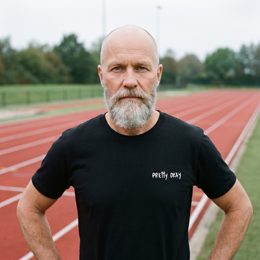 Pretty okay embroidered Finnish humour t-shirt in black, worn by Mikko at a running track, Very Finnish Problems