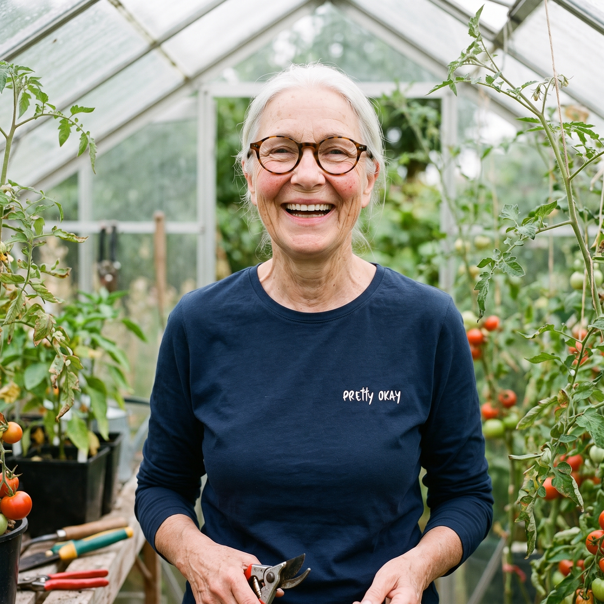 Pretty okay embroidered Finnish long sleeve tee in navy, worn by Raija in a greenhouse, Very Finnish Problems