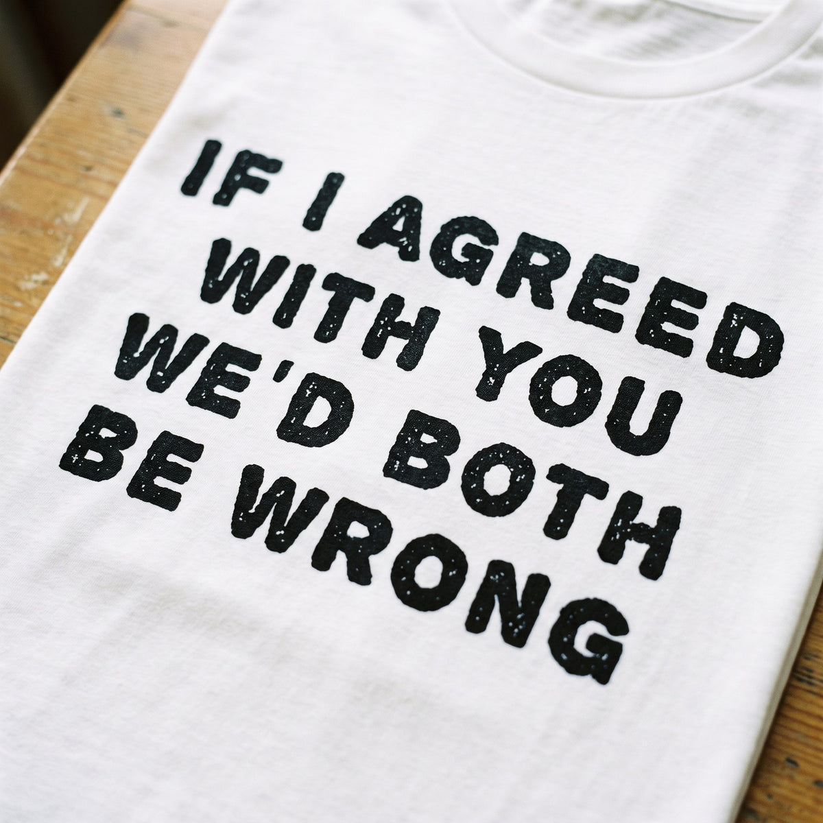 Close-up of the If I agreed with you we'd both be wrong print on white organic cotton, Very Finnish Problems