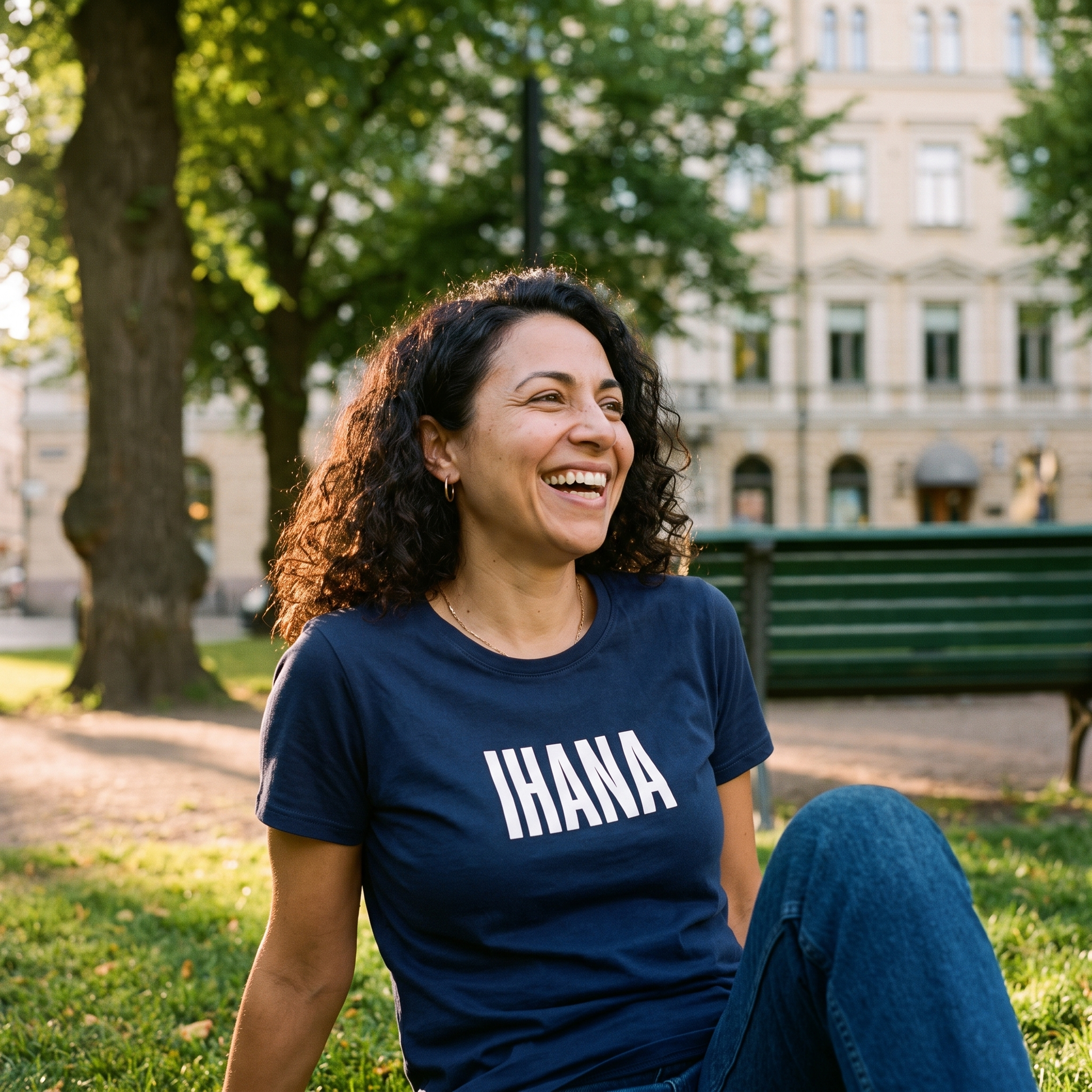 IHANA Finnish t-shirt in navy, worn by a woman laughing in a Helsinki park on a summer evening, Very Finnish Problems