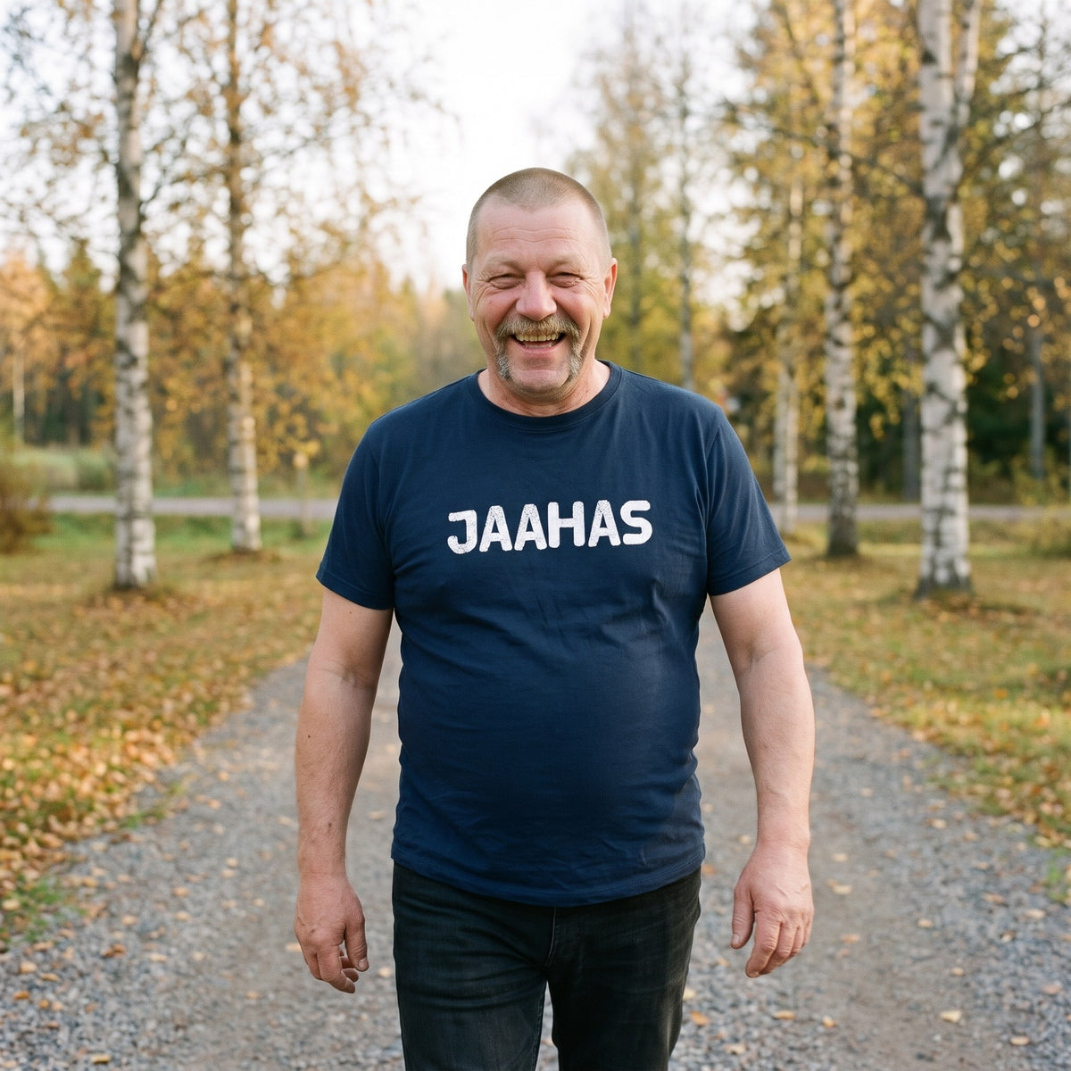 Jaahas Finnish language t-shirt in navy, worn by a man laughing as he walks down a gravel drive, Very Finnish Problems