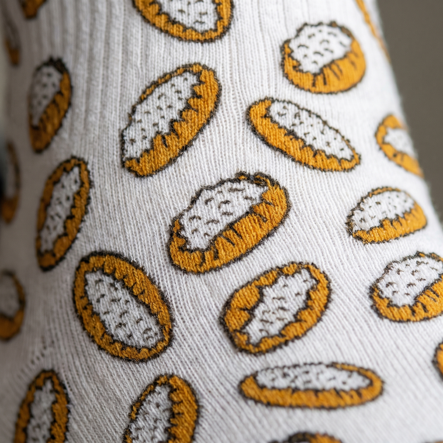 Karjalanpiirakka sock pattern close up showing the Karelian pie print knitted into the fabric, Very Finnish Problems