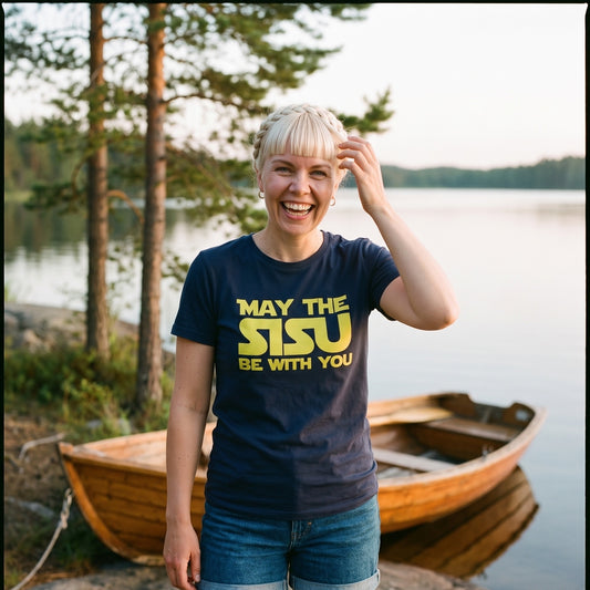 May the Sisu Be With You t-shirt in navy, worn by Venla beside a rowing boat on a granite lake shore in Finland, Very Finnish Problems