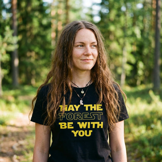 Woman in a Finnish forest clearing wearing the black May the Forest Be with You t-shirt, Very Finnish Problems