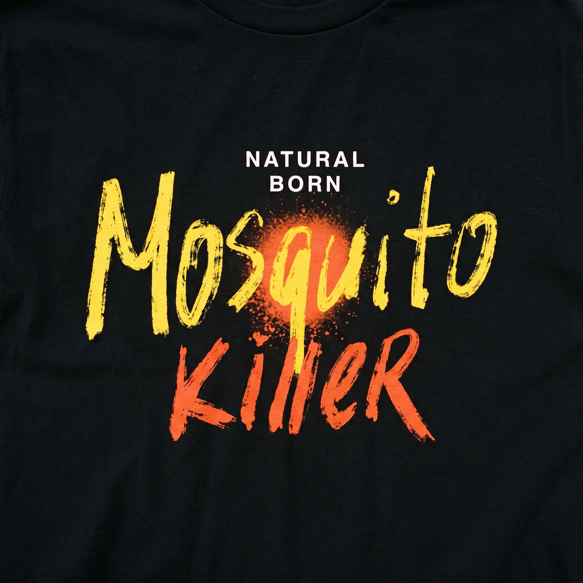Close-up of the Natural Born Mosquito Killer print on black t-shirt fabric, Very Finnish Problems
