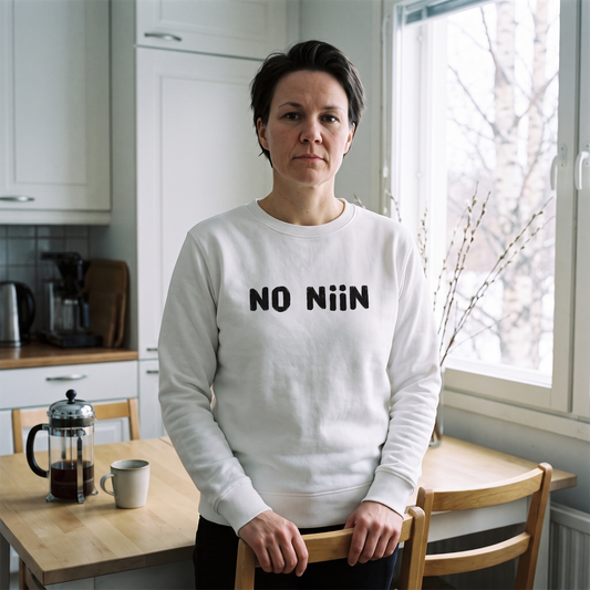 No niin eco-friendly Finnish language sweatshirt in white, worn by Katja at a Finnish kitchen table, Very Finnish Problems