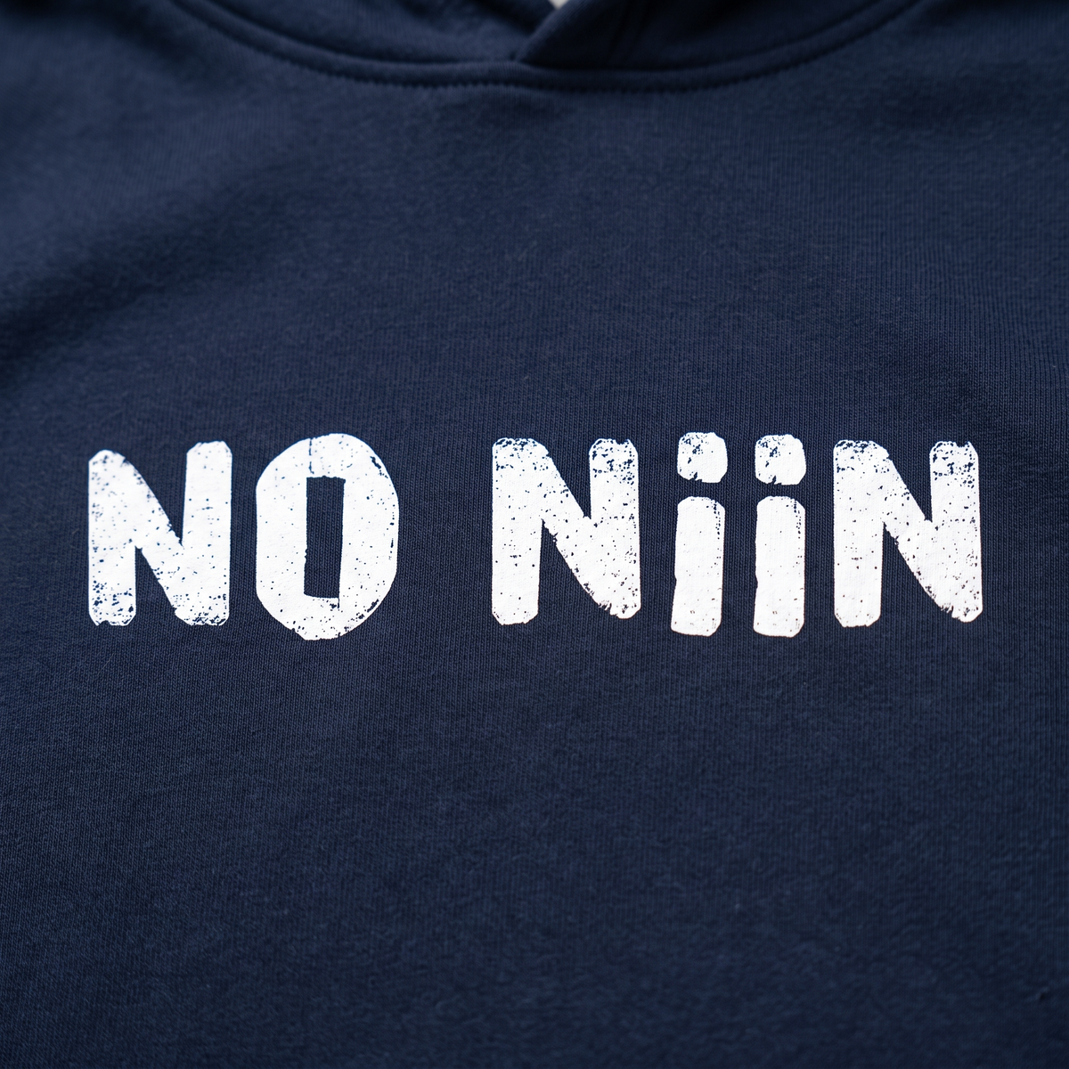 Close-up of the No niin print on French navy organic hoodie fleece, Very Finnish Problems