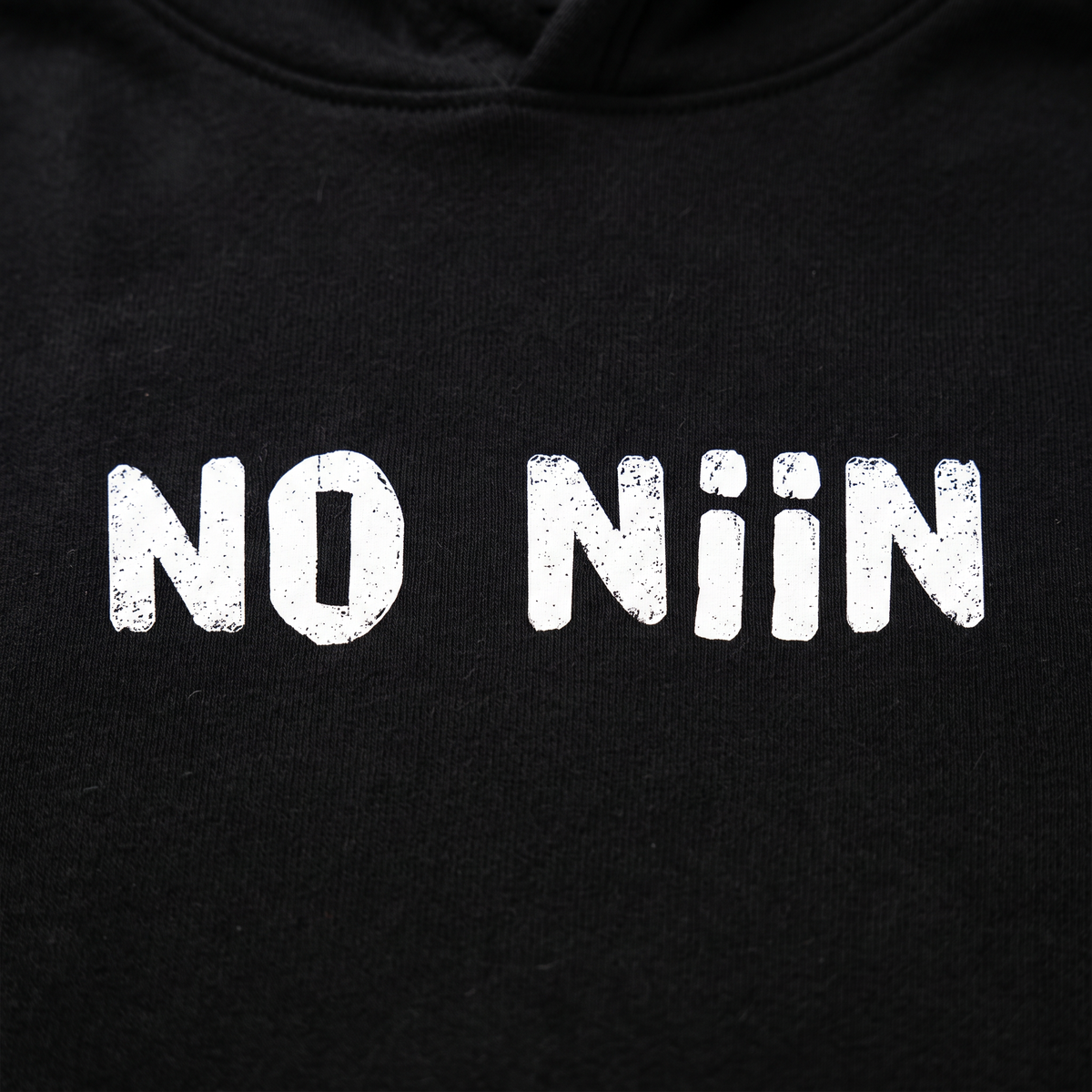 Close-up of the No niin print on black hoodie fleece, Very Finnish Problems