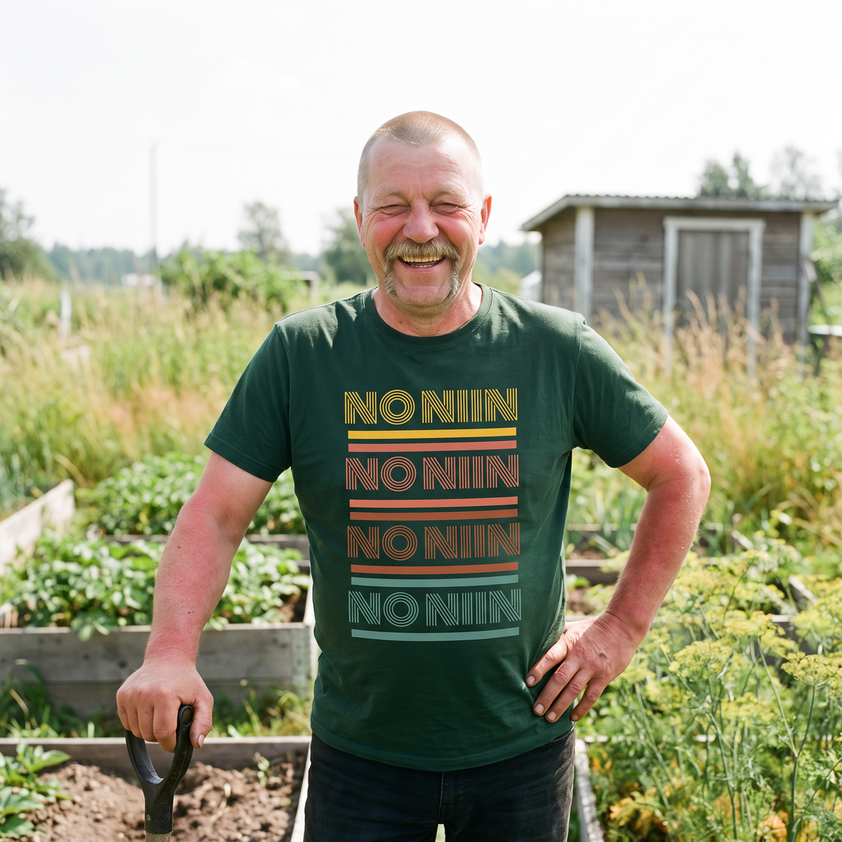 No niin retro Finnish language t-shirt in forest green, worn by Juha laughing on a Finnish allotment plot, Very Finnish Problems