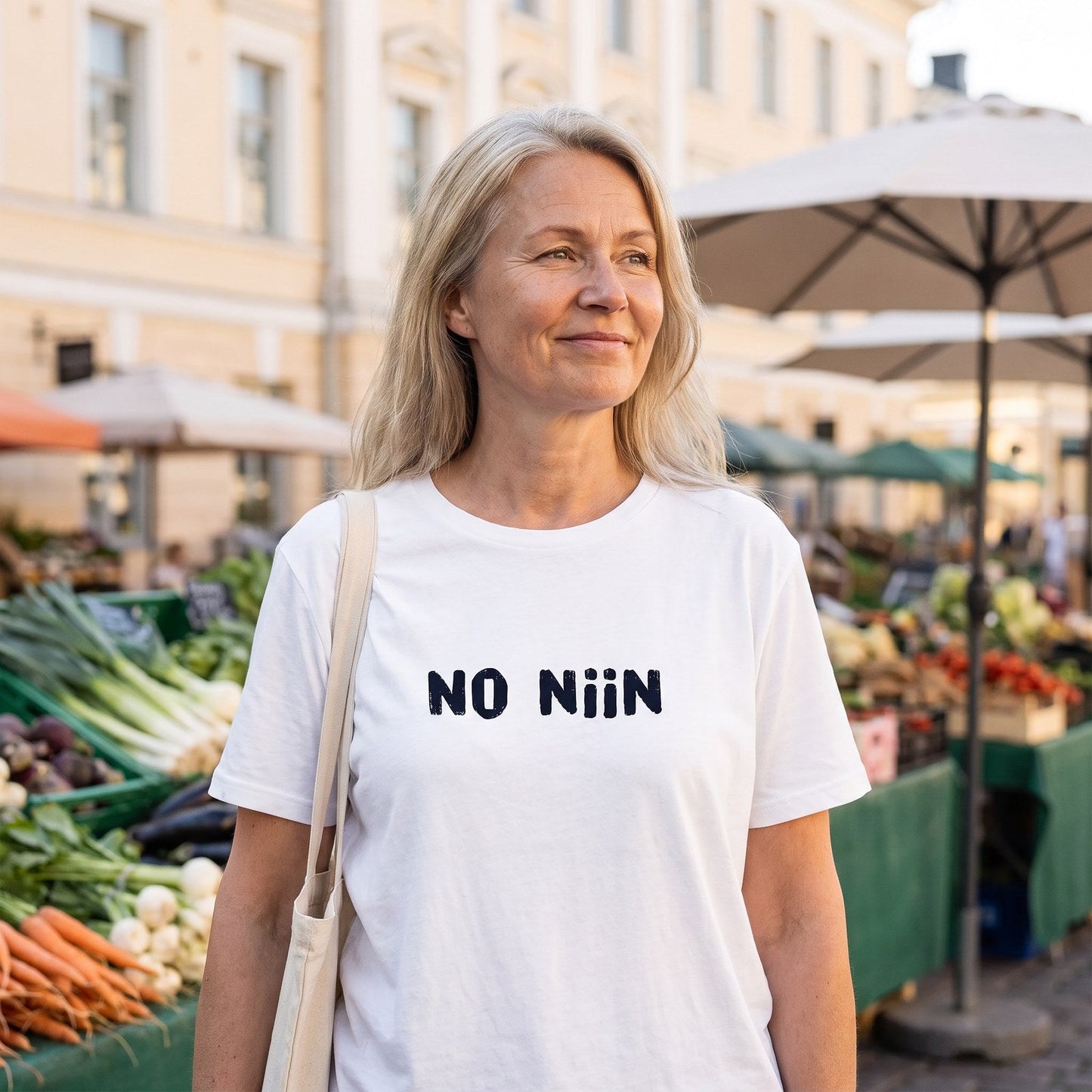 Woman wearing the white No niin Finnish language t-shirt at a Helsinki market square, Very Finnish Problems