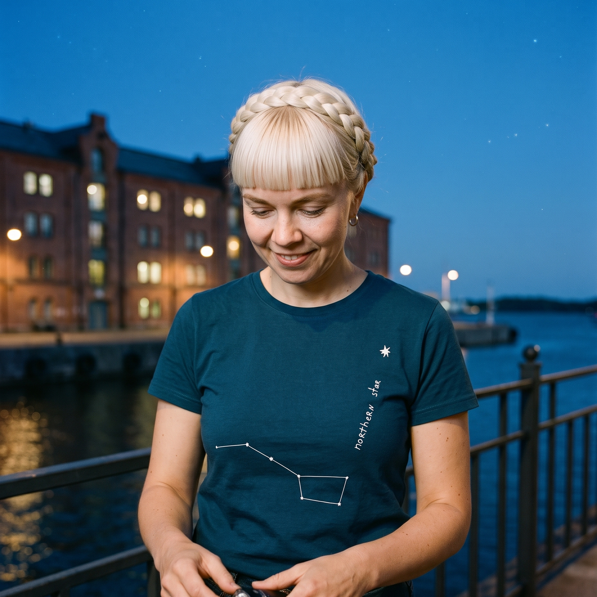 Northern Star 2 organic t-shirt in Stargazer, worn by Venla on a Helsinki quayside at night, Very Finnish Problems