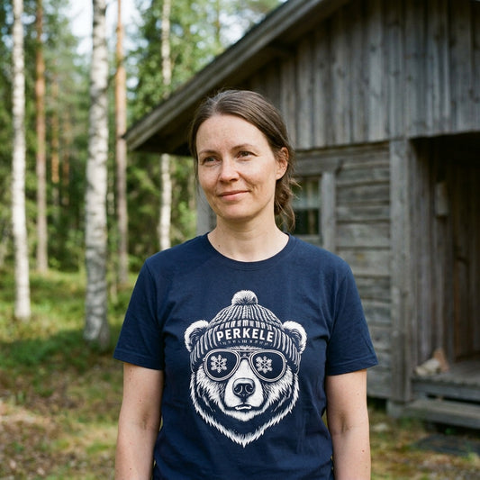 Woman by a Finnish summer cabin wearing the navy Perkele Bear t-shirt, Very Finnish Problems