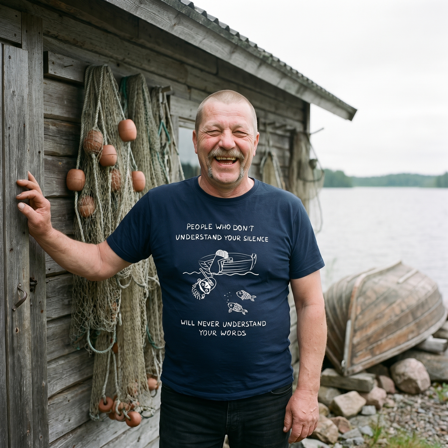 People Who Don't Understand Your Silence t-shirt in navy, worn by a man at a fishing hut, Very Finnish Problems