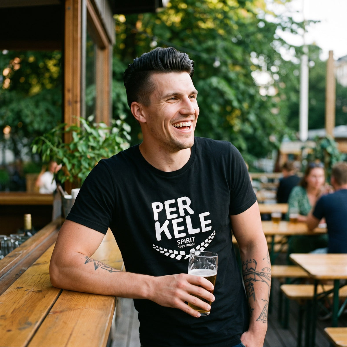 Perkele 100% Proof t-shirt in black, worn by Eetu at a summer bar terrace, Very Finnish Problems