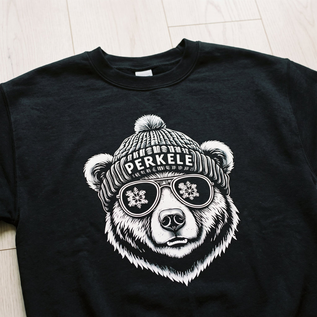 Close-up of the Perkele Bear print on a black sweatshirt, Very Finnish Problems
