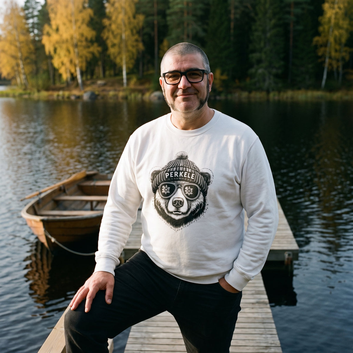 Perkele Bear sweatshirt in white, worn by Jaska on a lakeside jetty, Very Finnish Problems